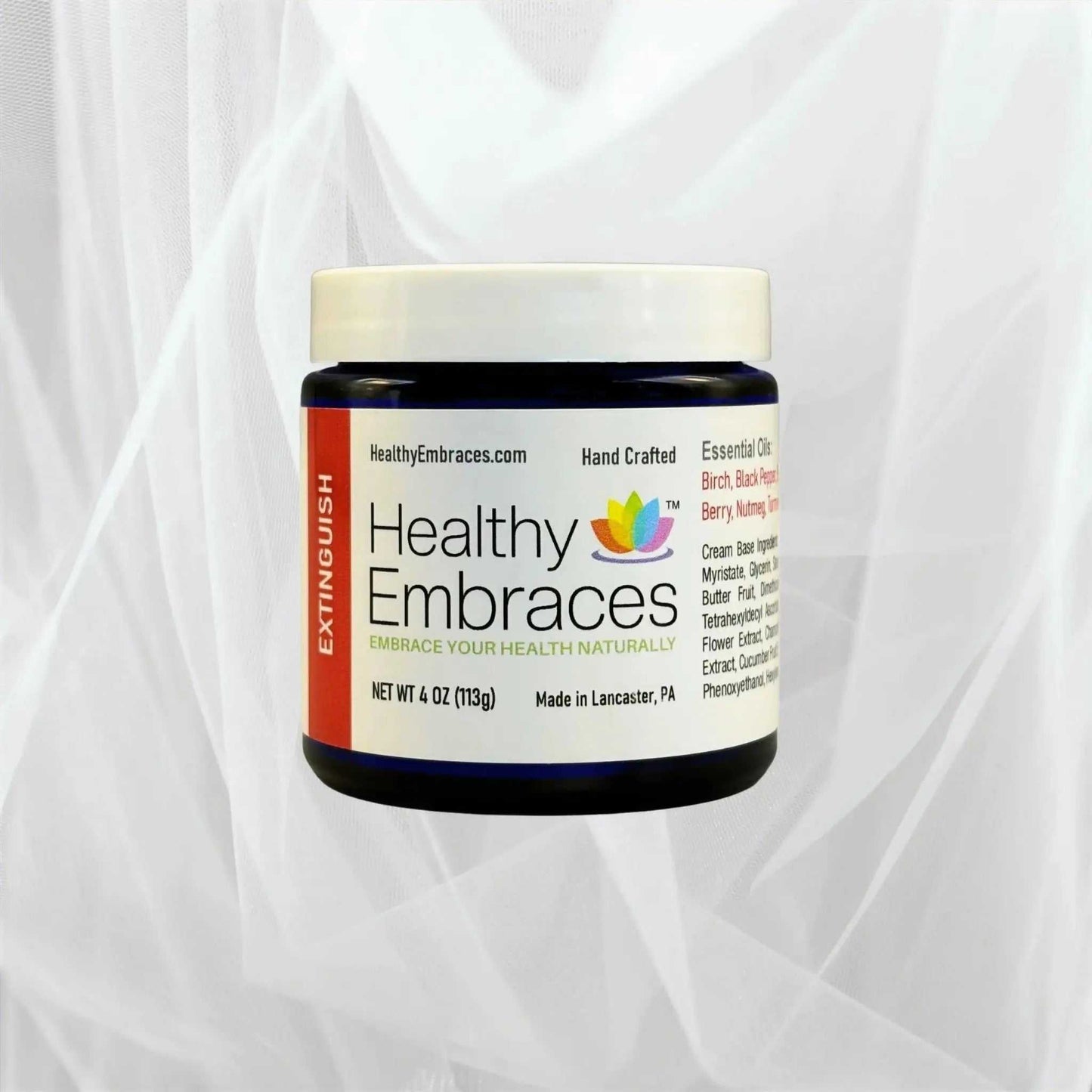 Healthy Embraces Extinguish Cooling Comfort Cream in a white jar with a blue lid, showing the product label and cream inside.
