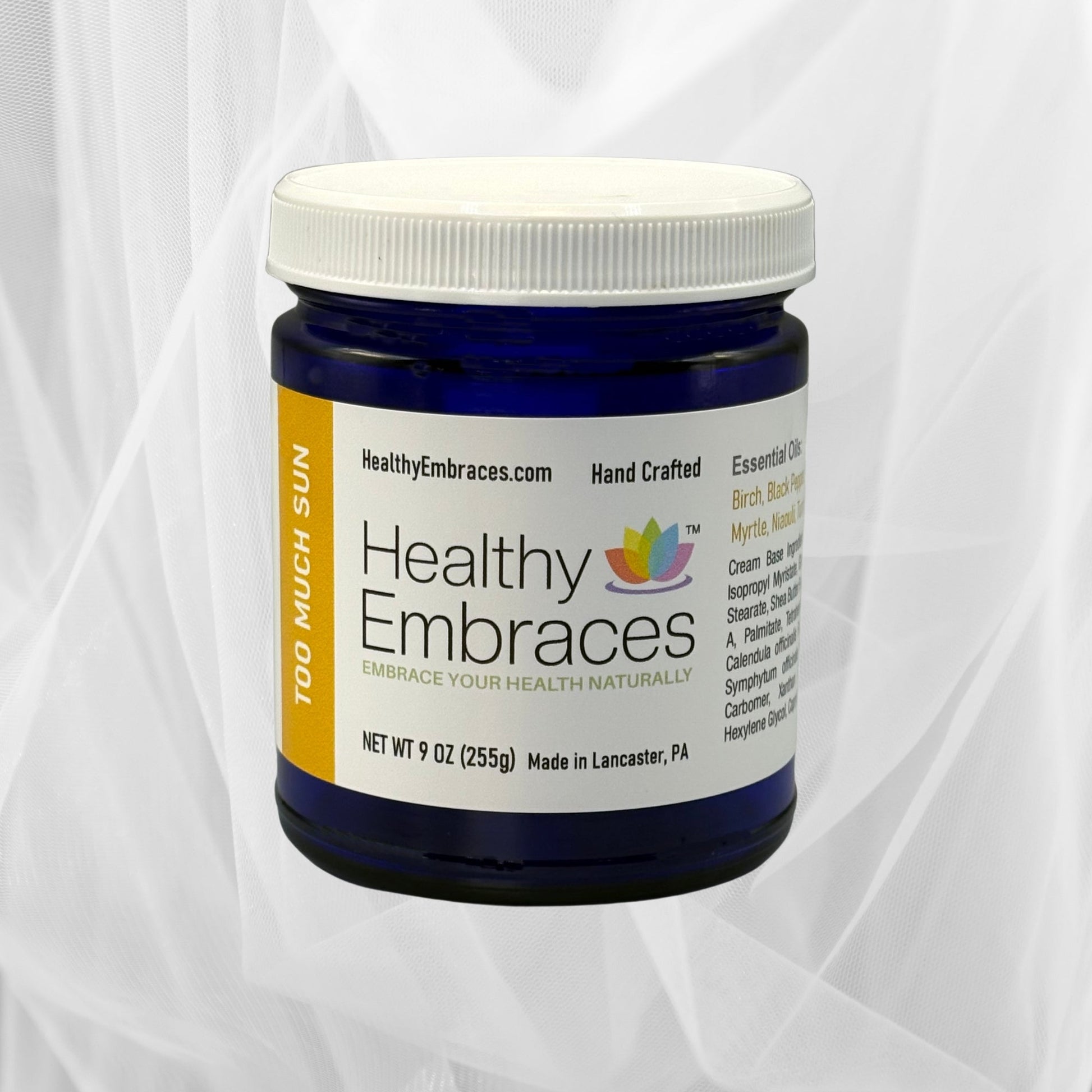 Healthy Embraces Too Much Sun Cream in a white jar, showing the cream's smooth texture and simple packaging.